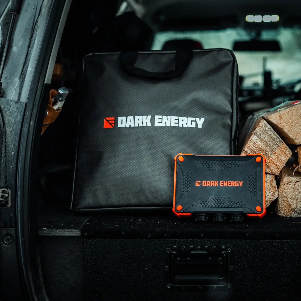 A Dark Energy solar panel case and power bank in the back of a vehicle.