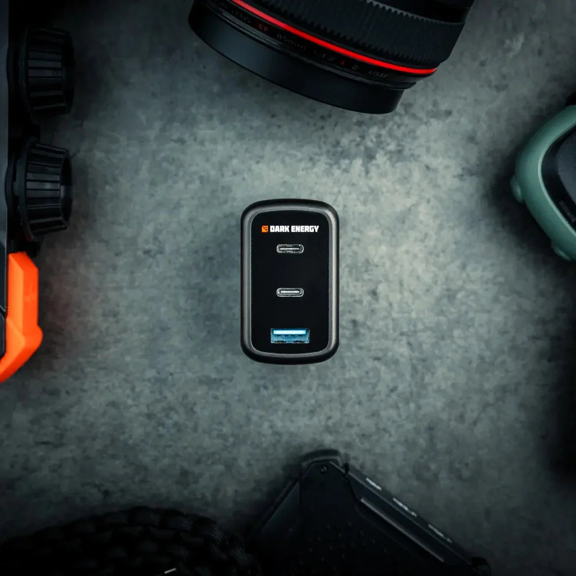 Overhead view of the Dark Energy 65W charger surrounded by gear.
