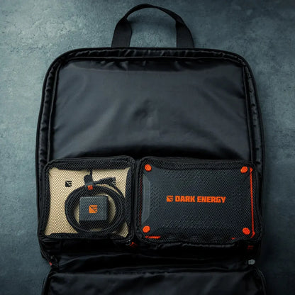 The Dark Energy charger stored in an open tech organiser pouch.